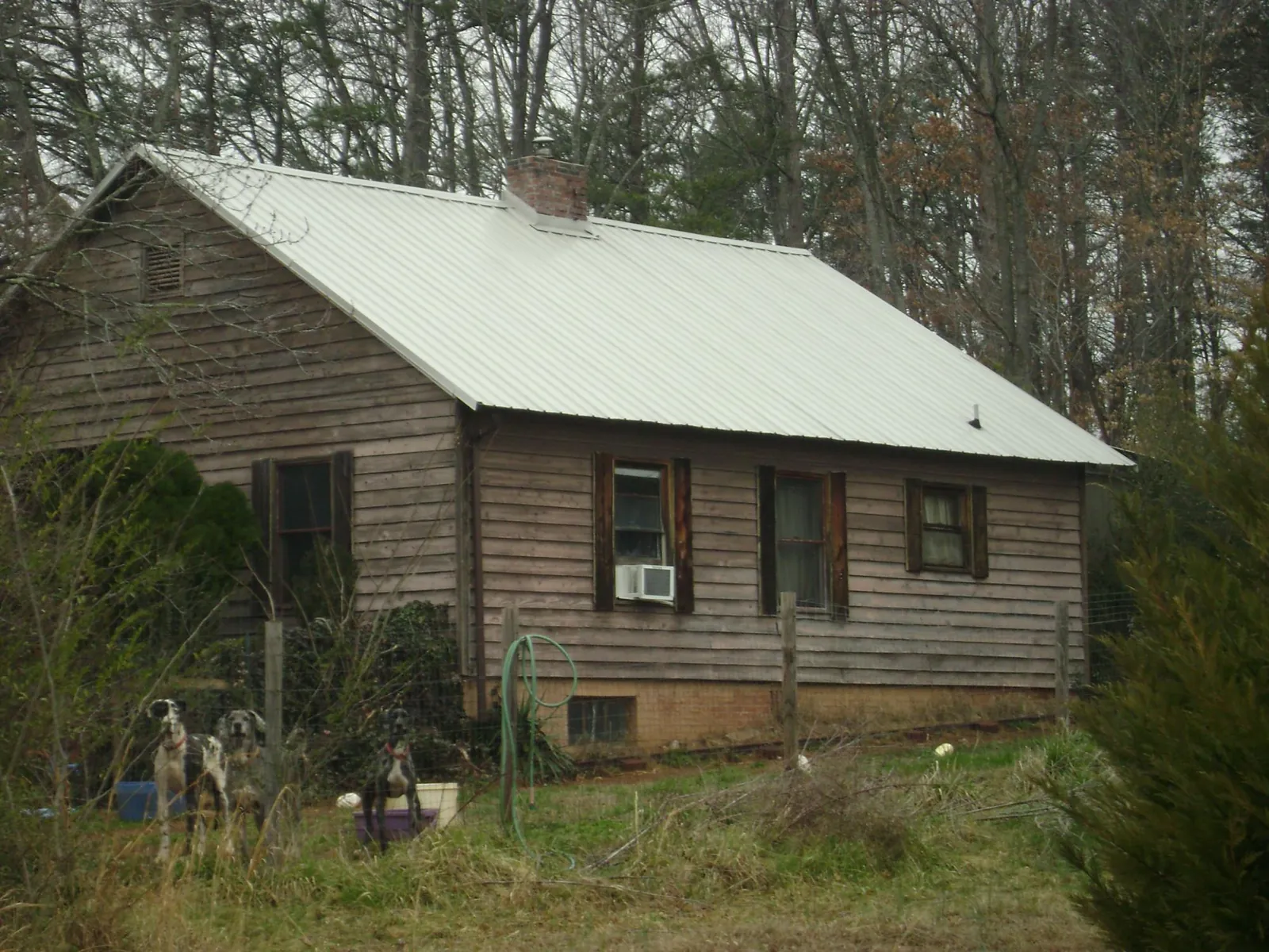 White metal roof on an old wood sided farmhouse, from a Metal Roof Installation job in Burket